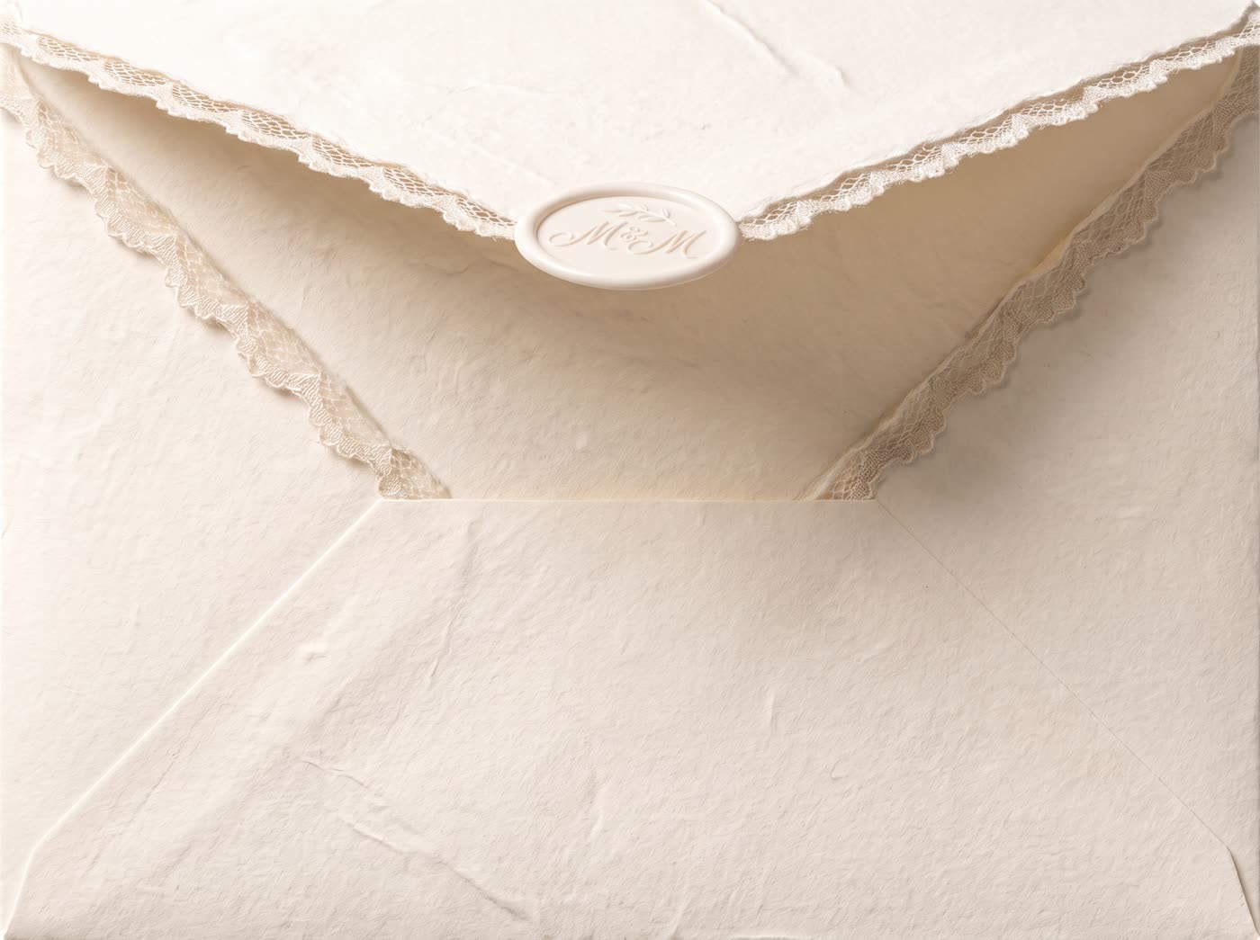 An ivory envelope with lace trim, sealed with an M and M wax seal